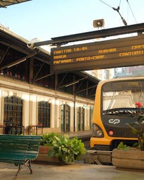 A train at Porto-Campanhã station with an electronic departure board in Porto, Portugal.