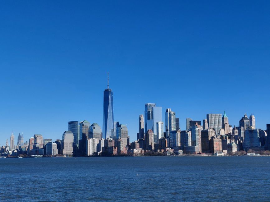 Stunning panoramic shot of the iconic New York City skyline against a clear blue sky.