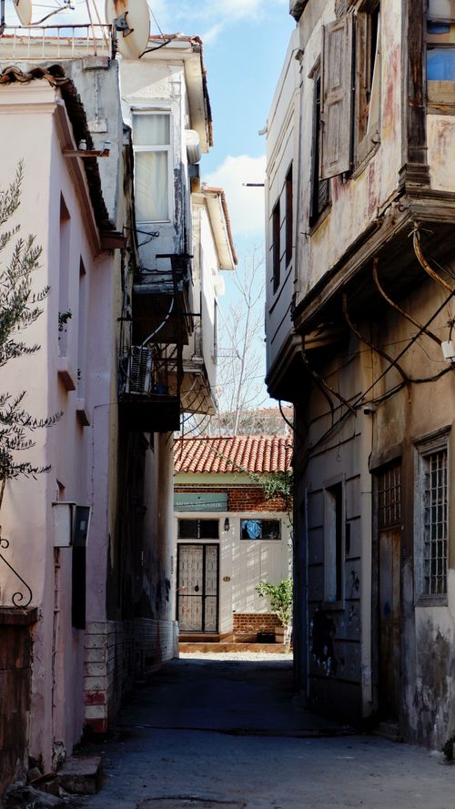 Free Charming old alleyway framed by historic Mediterranean buildings. Stock Photo