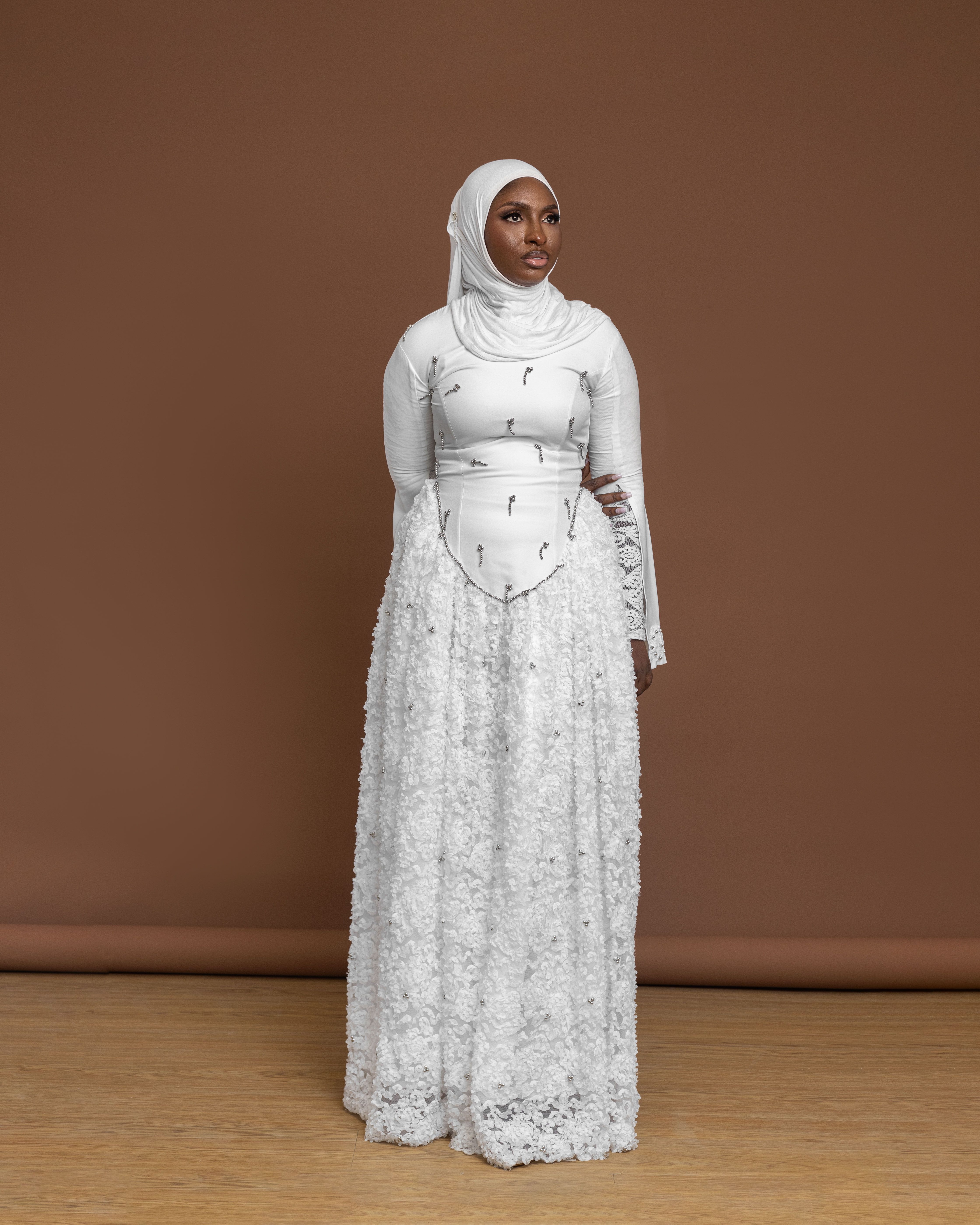 Elegant Woman in White Lace Dress and Hijab Indoors  Free Stock Photo