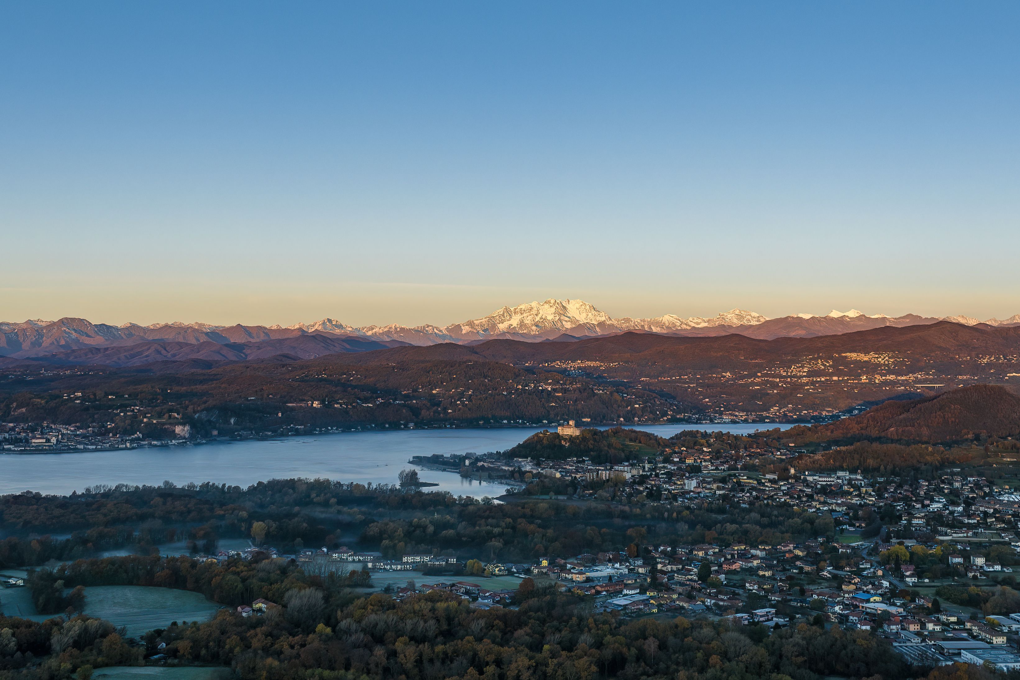 Aerial view over Lake Varese with Monte Rosa in the background during a clear day.