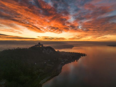 A breathtaking aerial view of Rocca di Angera at sunset, overlooking the serene Lake Maggiore.