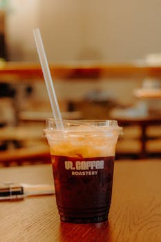 A refreshing iced coffee served in a clear plastic cup from UR Coffee Roastery.
