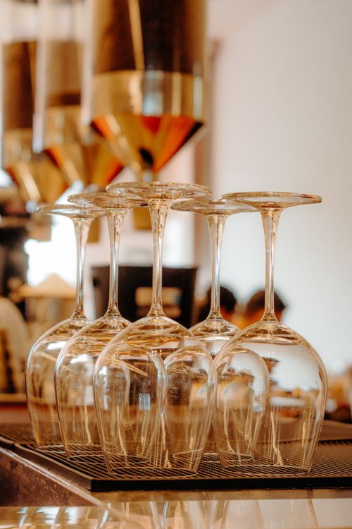 Free Upside-down wine glasses neatly arranged in a sophisticated restaurant setting. Stock Photo