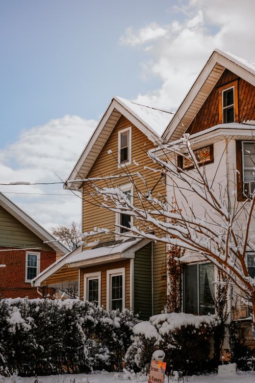 Free Picturesque suburban houses covered in snow on a sunny winter day. Stock Photo