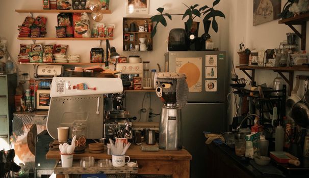 A cozy cafe interior featuring coffee equipment and a variety of products.