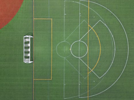 Aerial view of an empty soccer field showing a goal post and field markings.