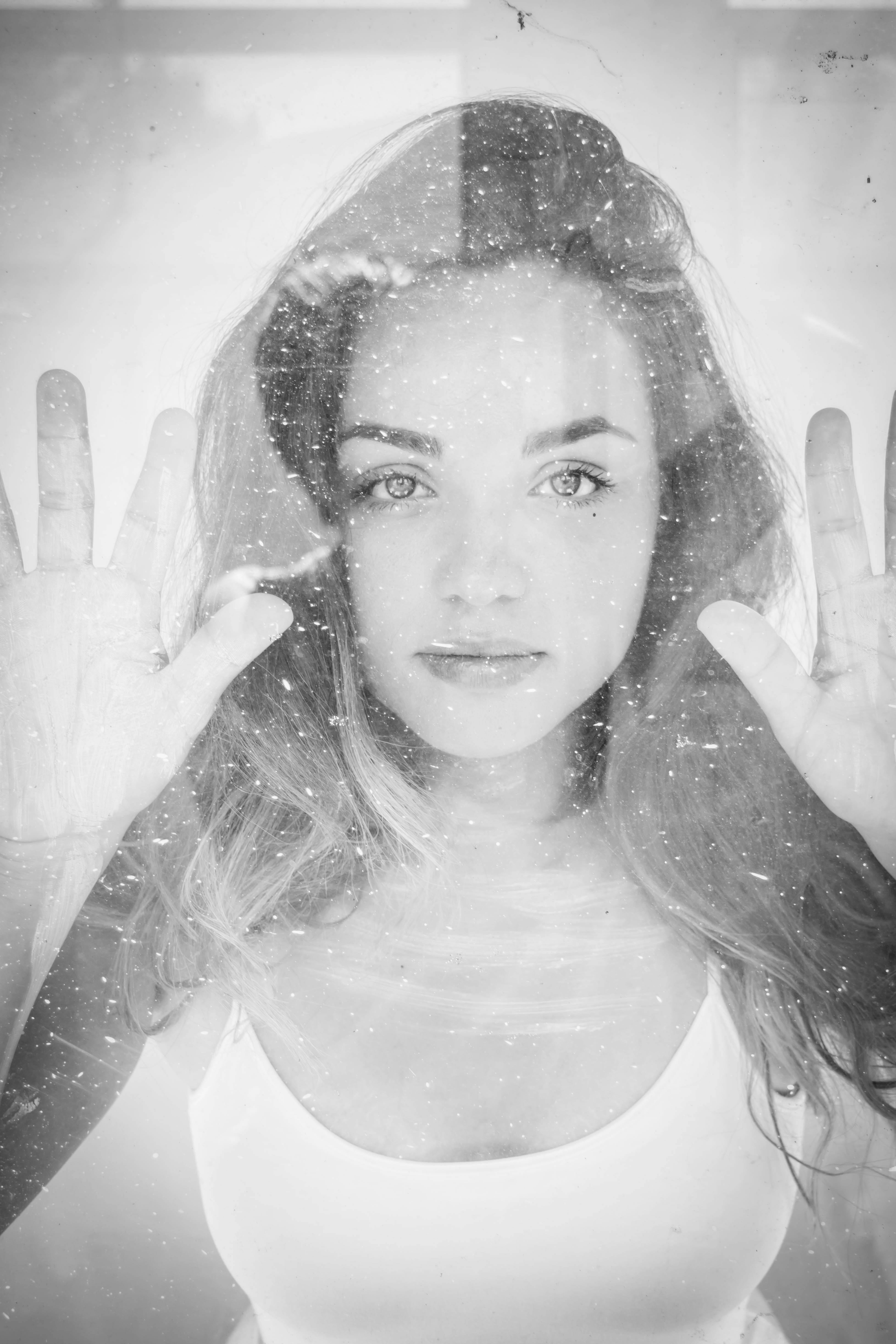Grayscale Photography of Woman Wearing Tank Top Holding on Glass ยท Free Stock Photo