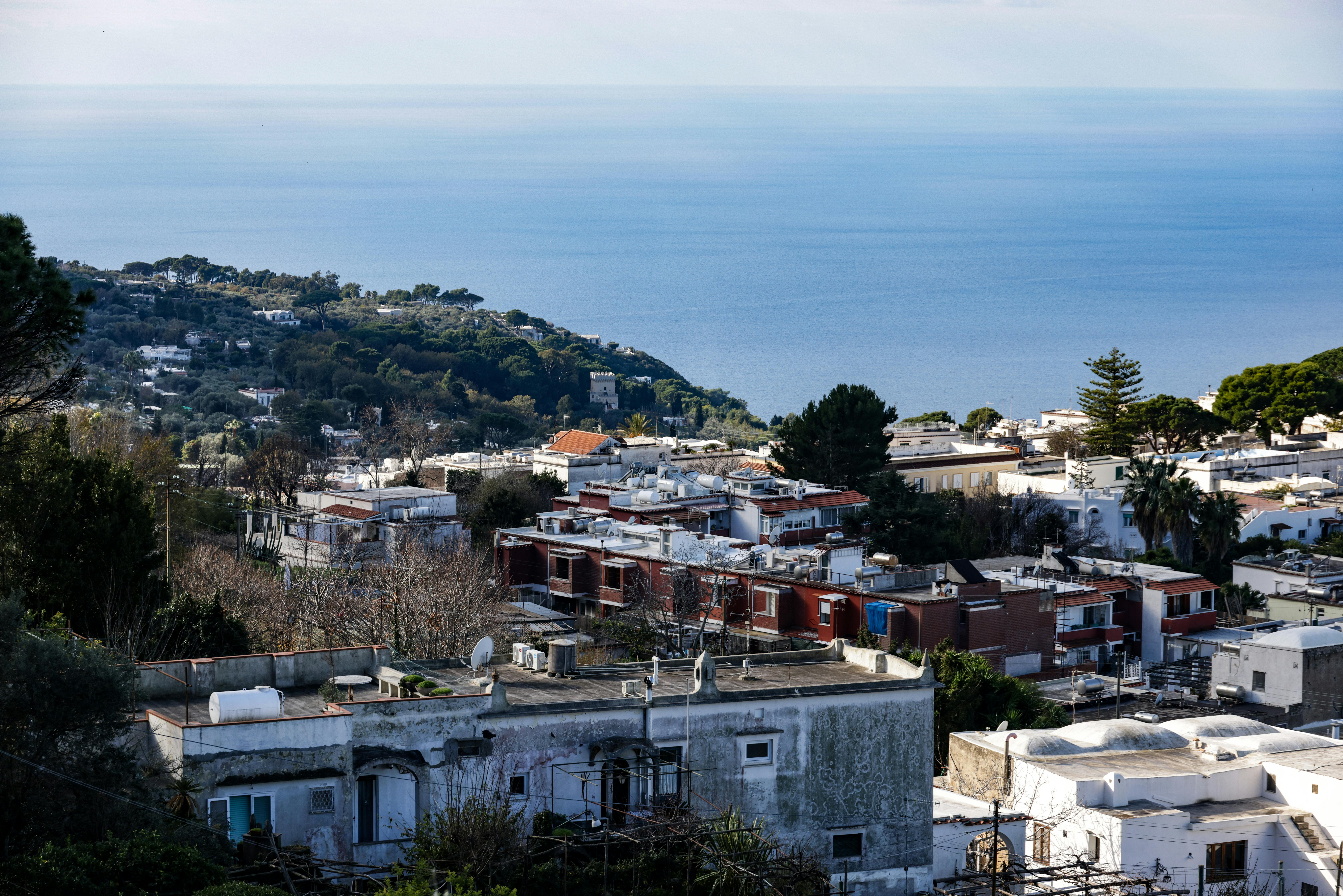 Aerial view of Capri's coastline with Mediterranean Sea backdrop and charming Italian architecture. - Capri