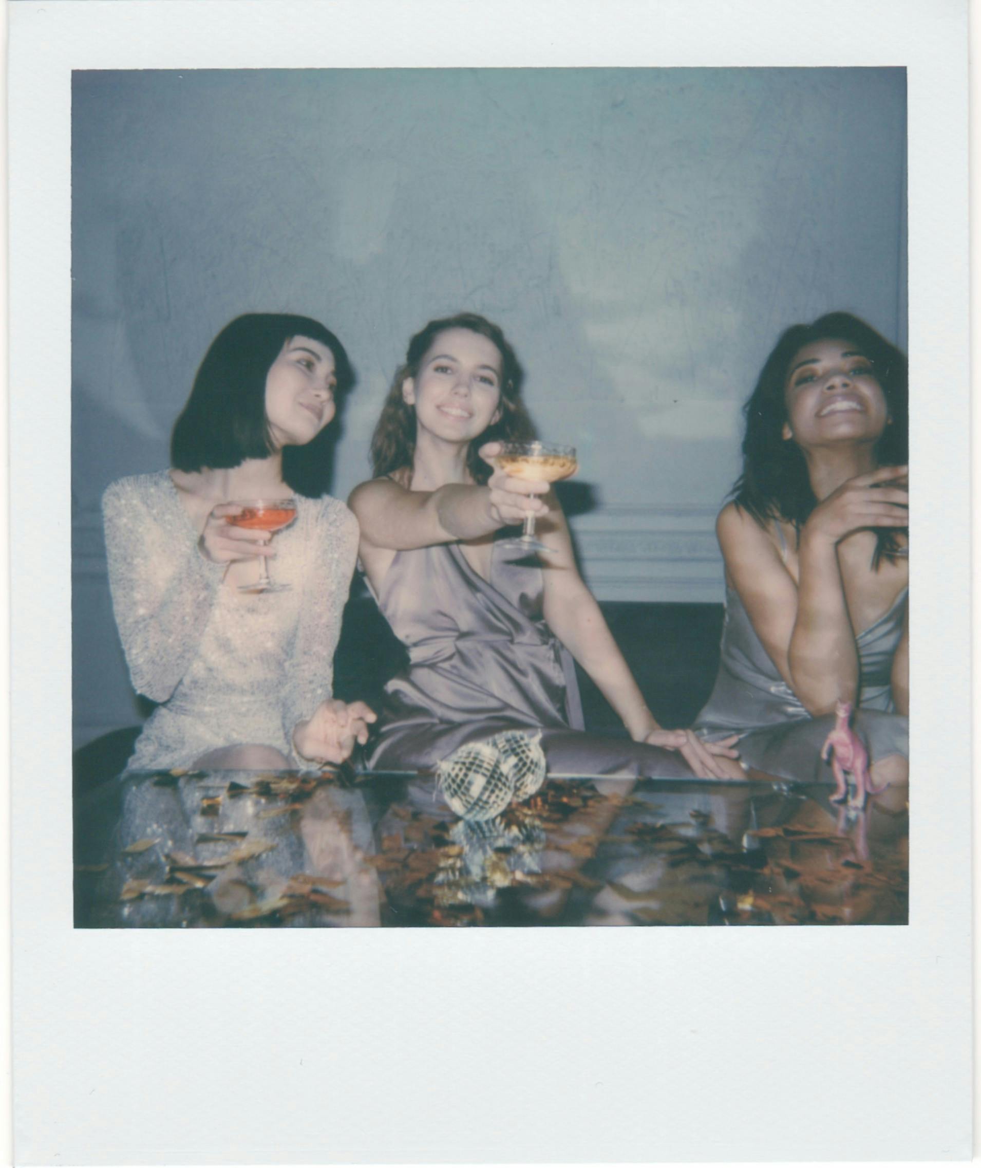 instant photo of three women drinking