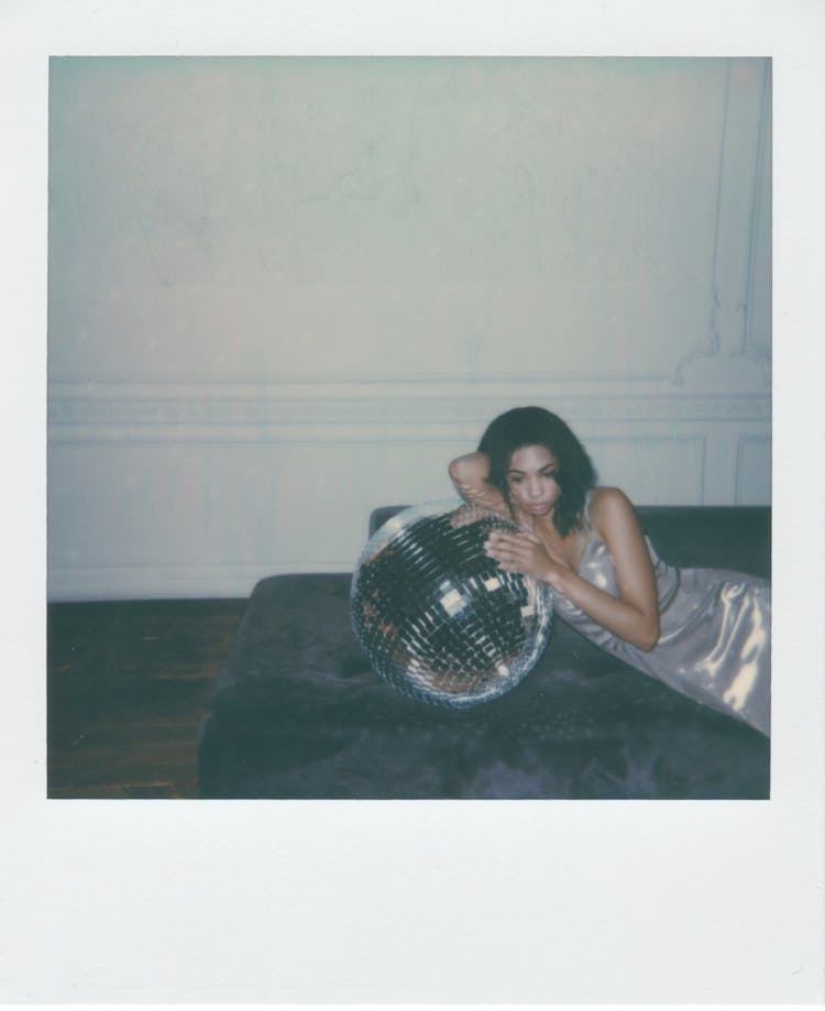 Woman Leaning On A Mirror Ball