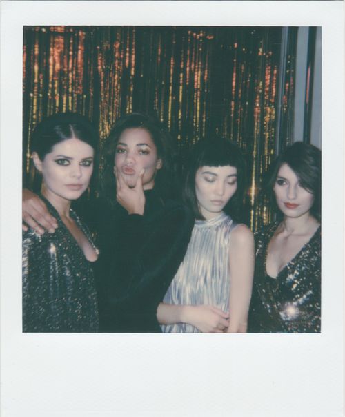 Free A group of fashionable women posing at a party in dazzling outfits and shimmering backdrop. Stock Photo