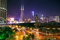 夜晚的城市景观令人着迷，灯火通明的摩天大楼和繁忙的路灯步道点缀其中