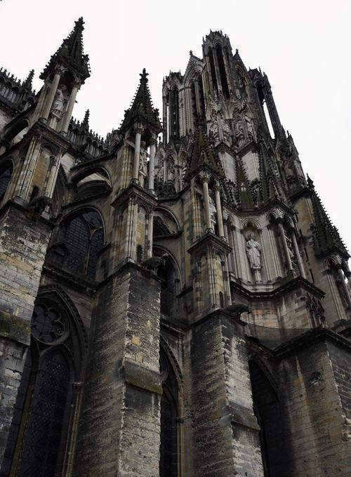 Free Majestic Gothic cathedral spire in dramatic overcast lighting, showcasing intricate architectural details. Stock Photo