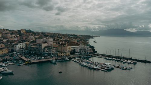 Free Stunning aerial shot of Naples, Italy, showcasing the historic port, coastal landscape, and vibrant cityscape. Stock Photo