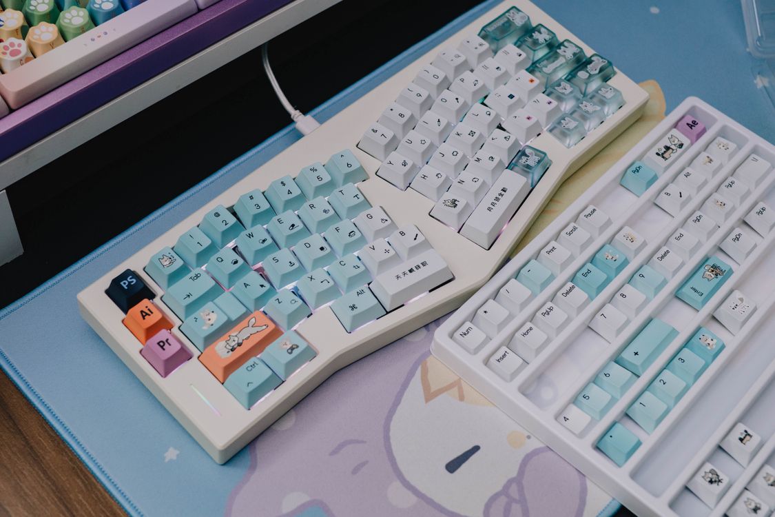 Colorful Custom Keyboards on Pastel Desk Mat · Free Stock Photo