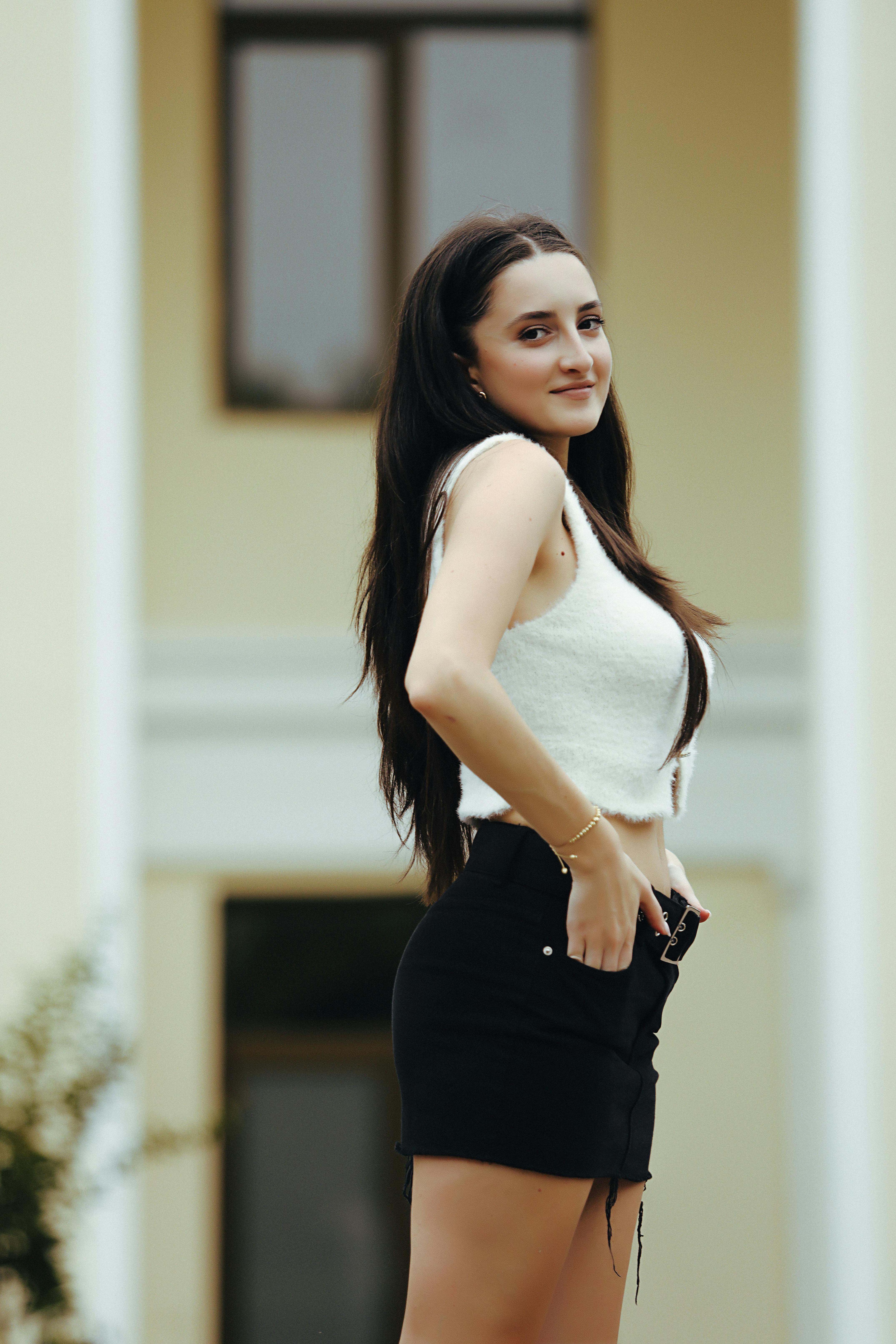 Stylish outdoor portrait of a woman posing elegantly in Tbilisi, Georgia.