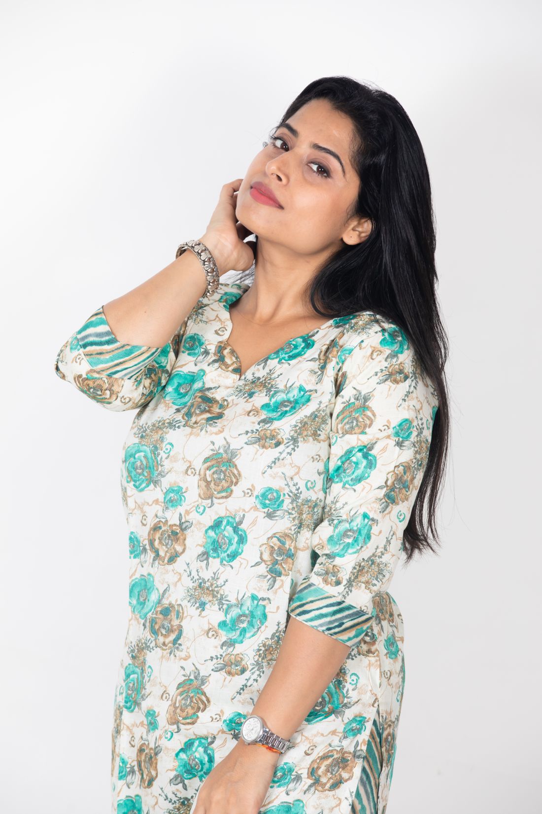 Woman in a white and teal floral print kurta