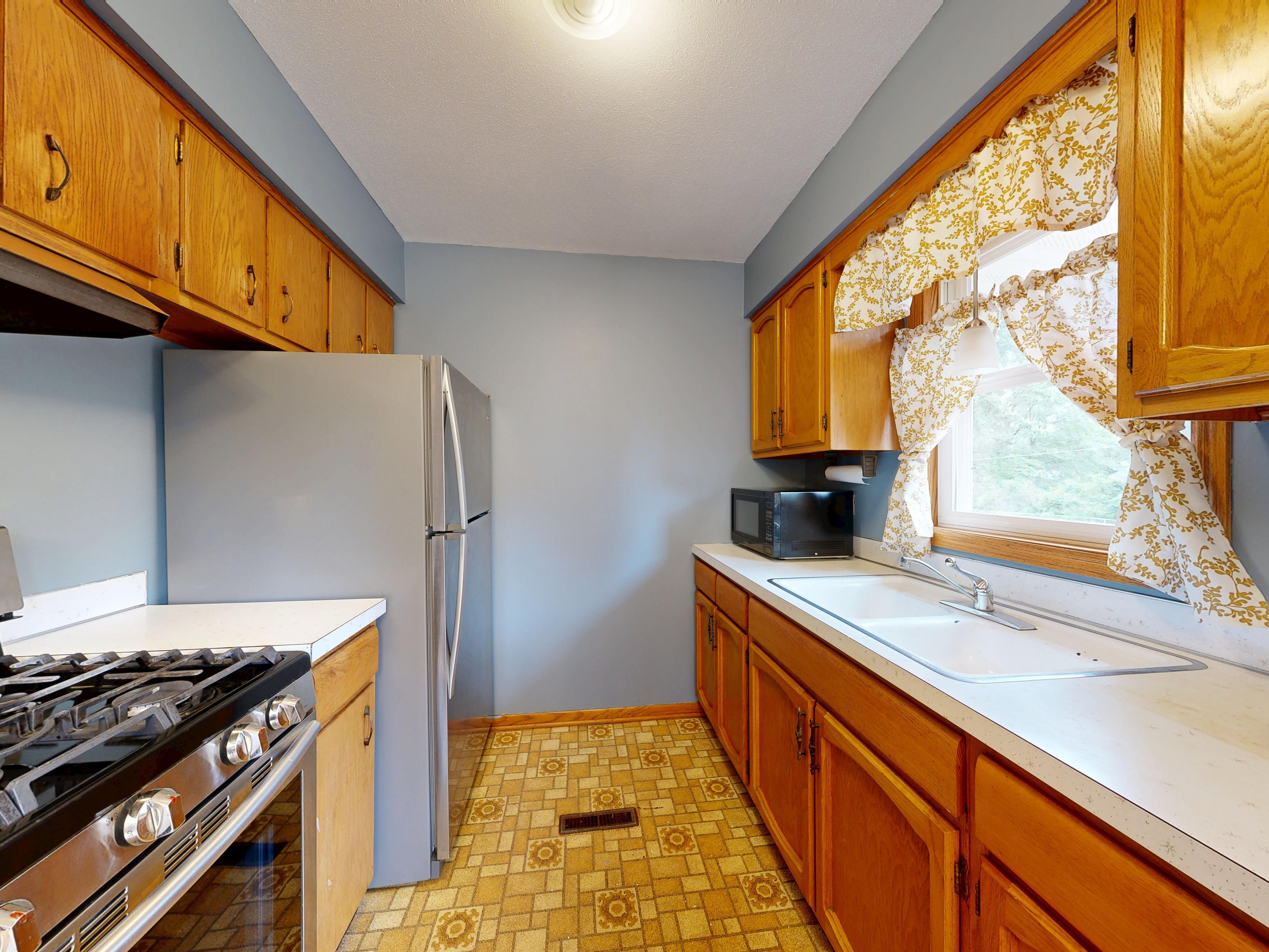 Modern Kitchen with Wooden Cabinets and Appliances · Free Stock Photo