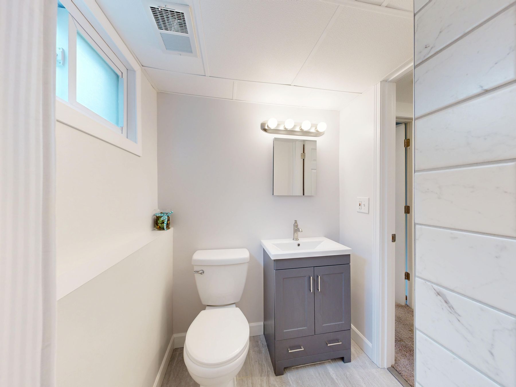 Compact bathroom vanity with storage in a small modern bathroom
