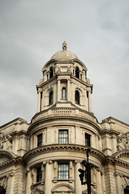 Free Stunning facade of a historic building showcasing classic architectural elements under a serene sky. Stock Photo