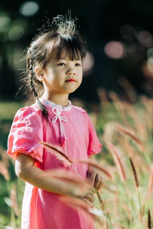 Young Girl in Pink Dress Enjoying Nature Outdoors · Free Stock Photo