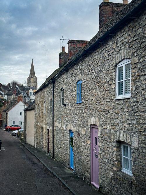 Free Stone cottages and church spire in a quaint Malmesbury street. Stock Photo