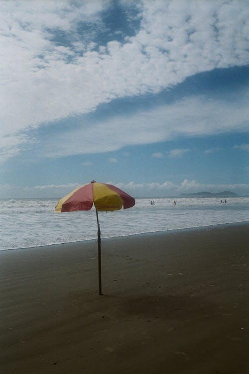 Yellow and Red Umbrella on a Beach