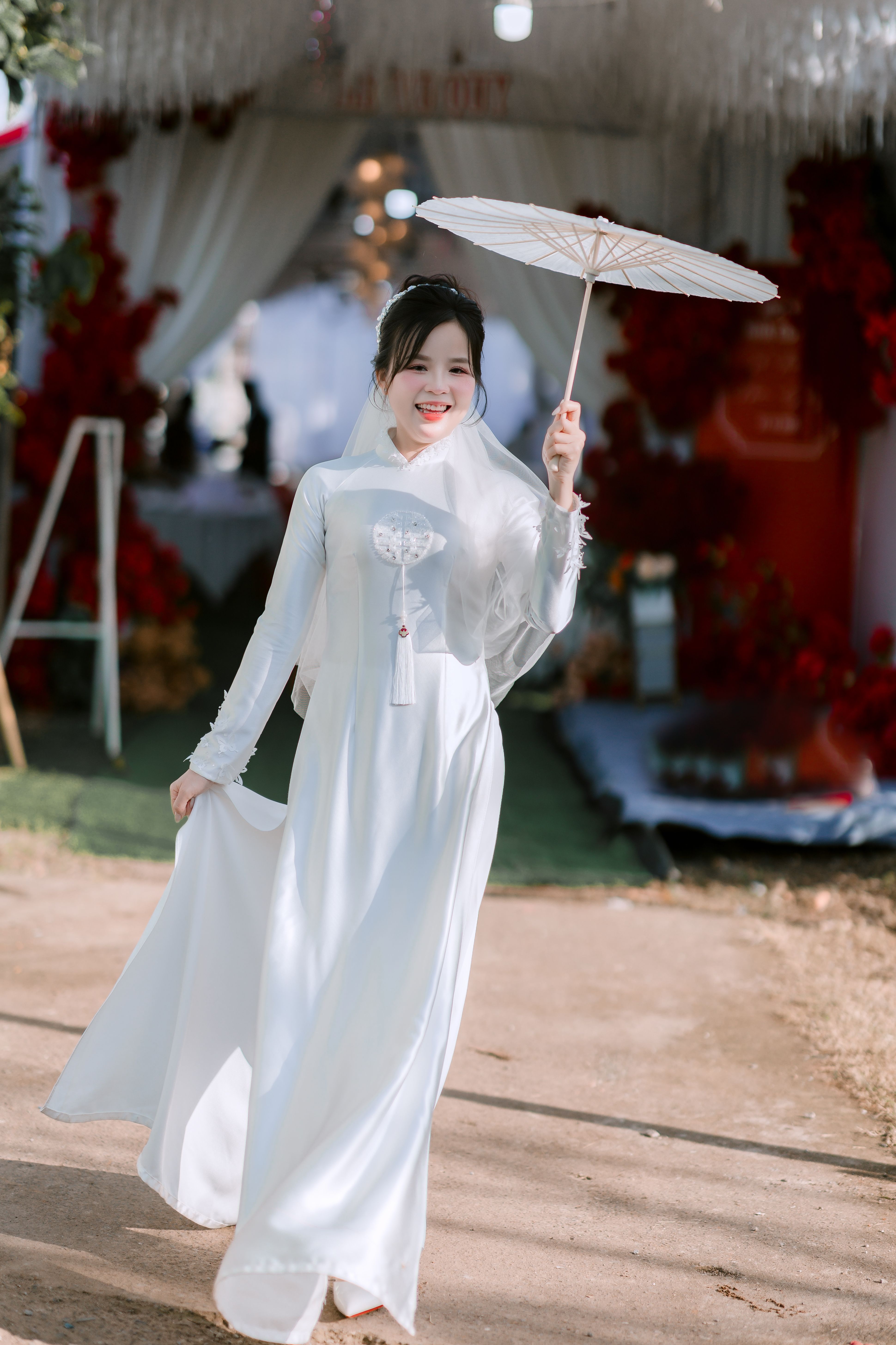 Smiling young woman in white traditional dress outdoors · Free Stock Photo