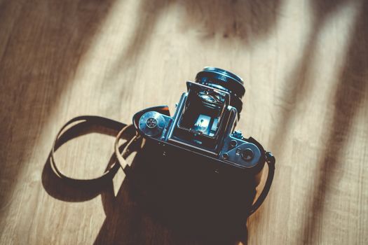 Black Dslr Camera on Brown Surface