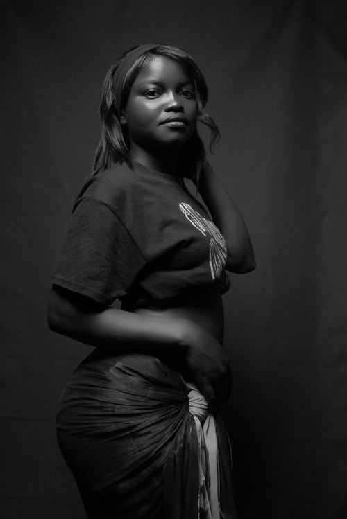 Free Striking black and white portrait capturing a confident young woman in casual attire. Stock Photo