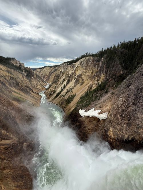Free Spectacular view of Yellowstone's canyon with roaring waterfall and rugged cliffs. Stock Photo