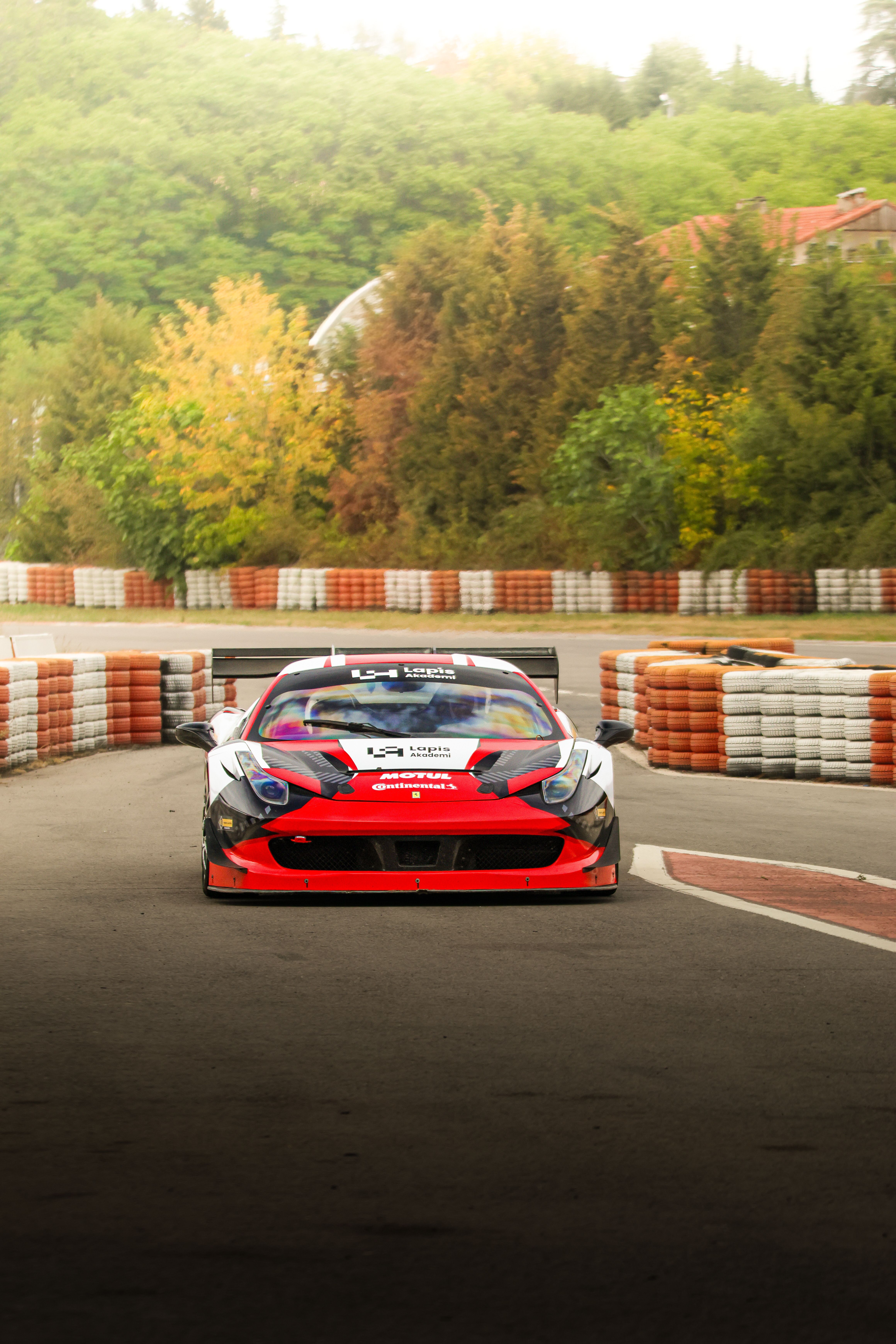 Racing Car on Track Surrounded by Nature · Free Stock Photo