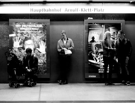 Black and white scene of people at Stuttgart Central Station in Baden-Württemberg.