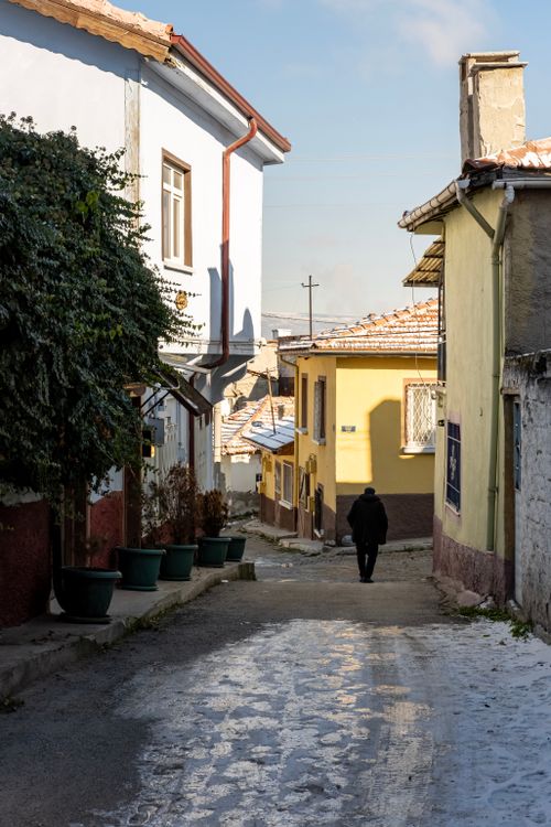 Free A quiet street scene in Eskişehir, Türkiye during winter with a lone person walking. Stock Photo