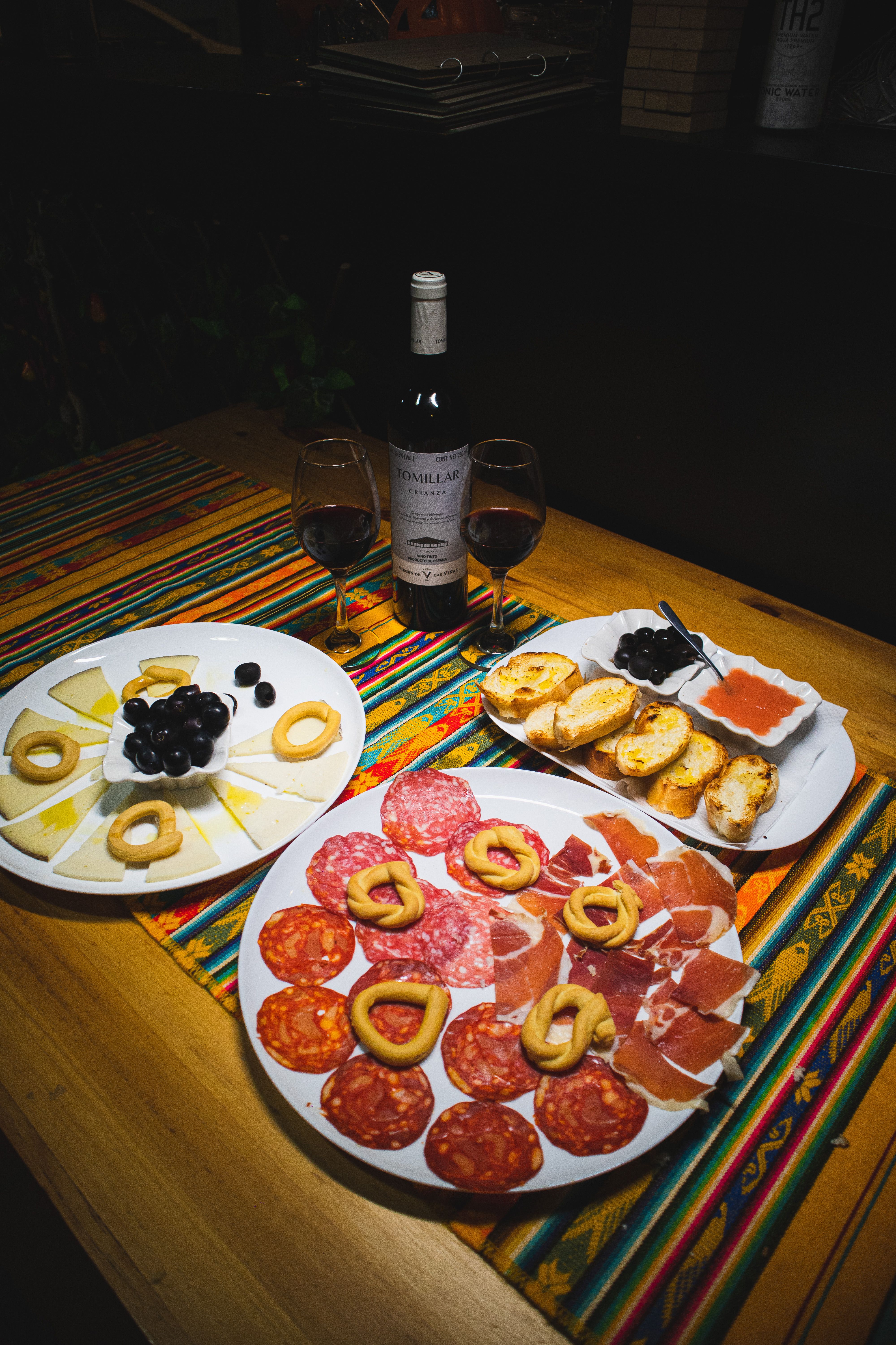 Delicious Spanish Tapas and Wine on Wooden Table · Free Stock Photo