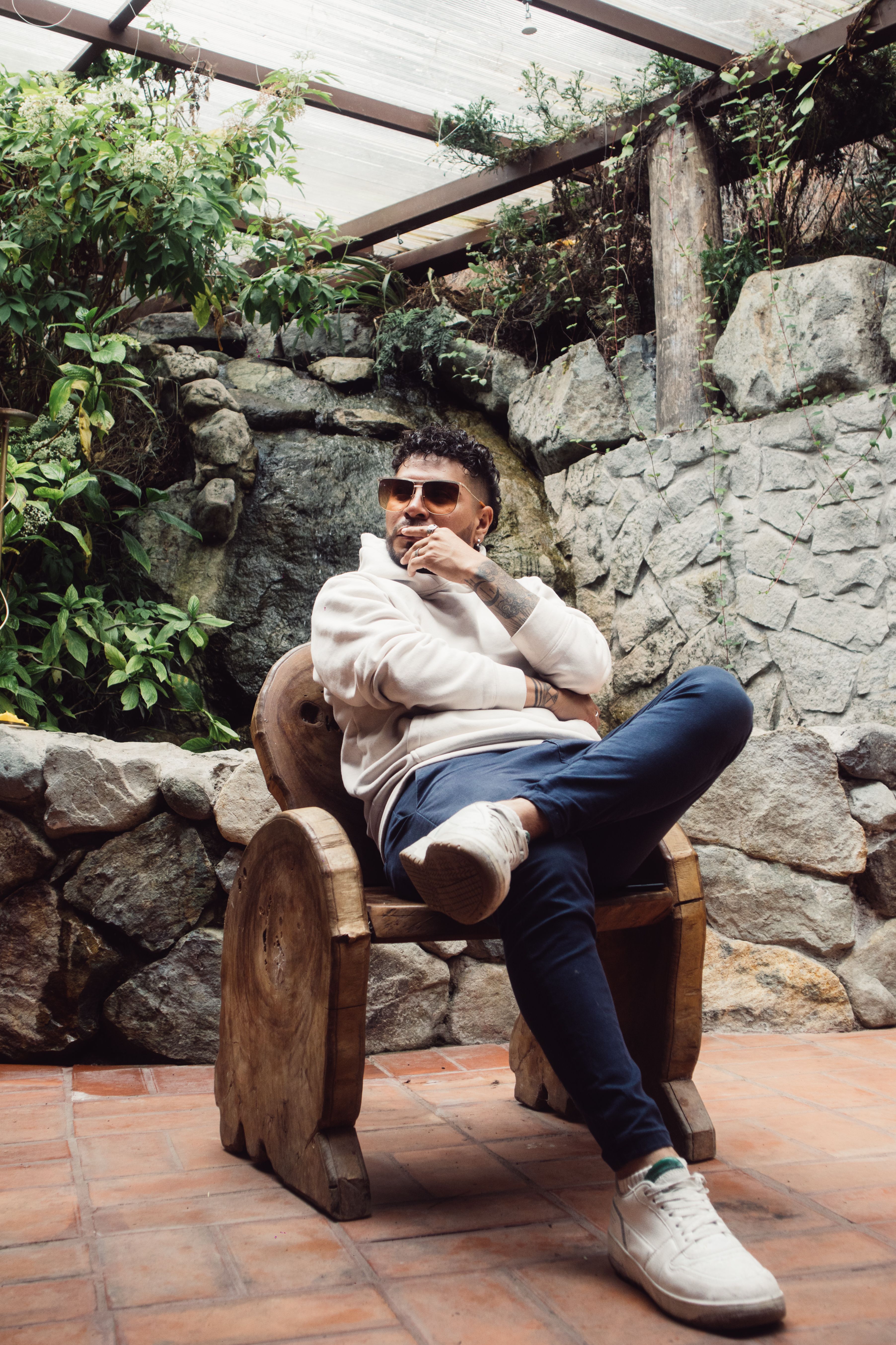 Stylish Man Relaxing in Rustic Outdoor Setting · Free Stock Photo