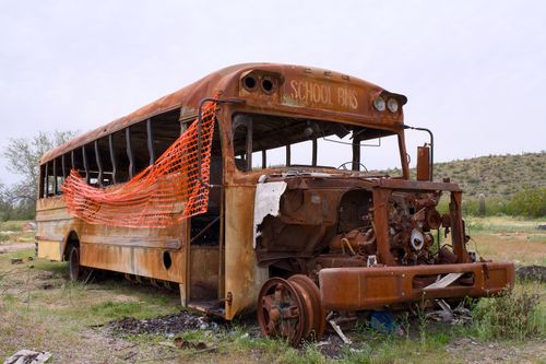 Free A decaying and rusted school bus left abandoned in the Arizona desert, conveying urban decay. Stock Photo