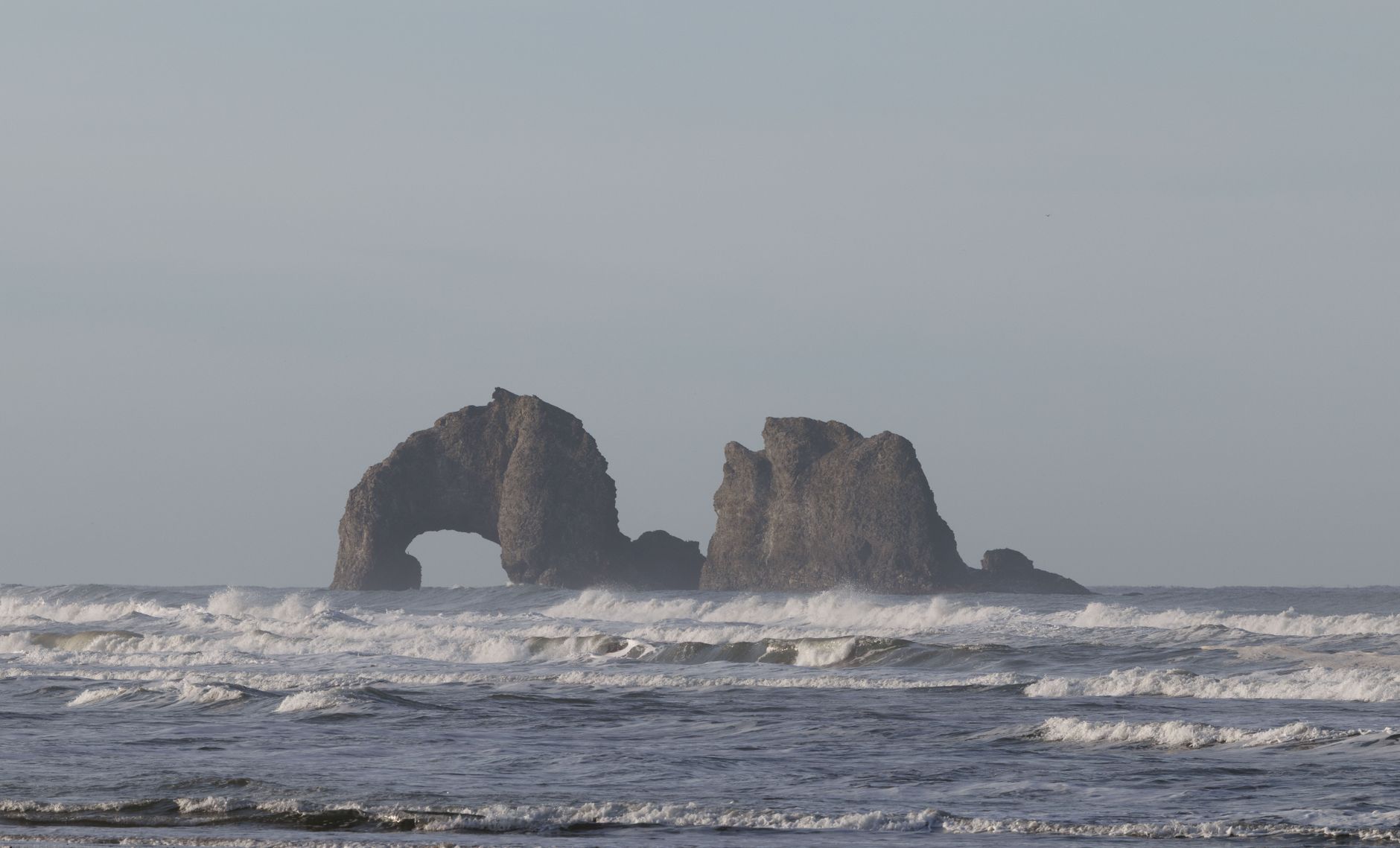 Beautiful coastal rock formations with waves in the Pacific Ocean near Oregon.