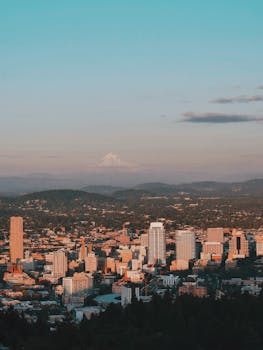 Picturesque view of Portland downtown and Mount Hood at twilight, showcasing urban beauty.
