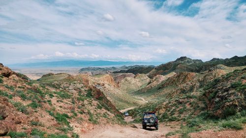 Free 4x4 vehicles navigate rugged mountain terrain under vibrant skies, epitomizing off-road adventure. Stock Photo
