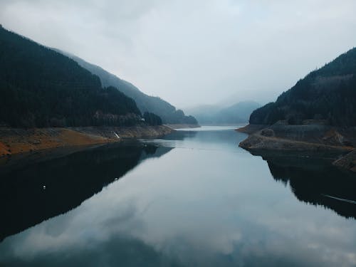 A Lake Between Mountains Under The Cloudy Day