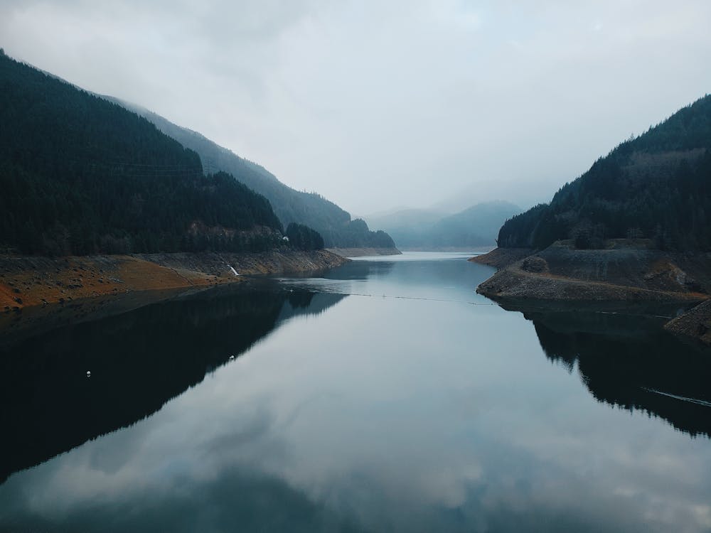 A Lake Between Mountains Under The Cloudy Day