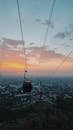 Cableway above city during bright sunset
