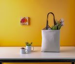 Two White Ceramic Mugs and a white bag on Wooden Table