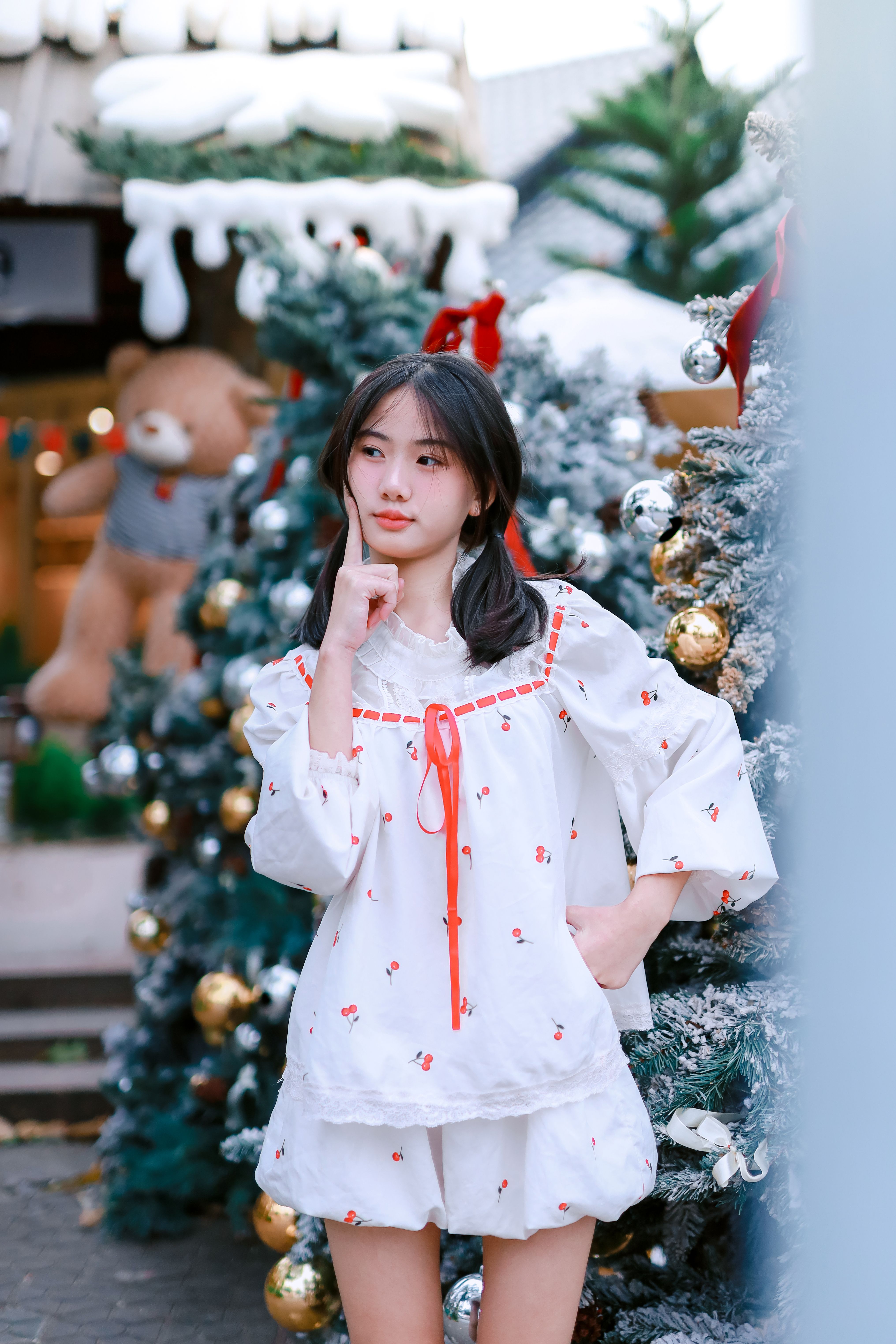 Young Woman Poses Amidst Festive Christmas Decor · Free Stock Photo
