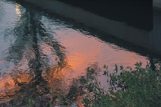 Tranquil waters reflecting sunset colors creating a relaxing scene.