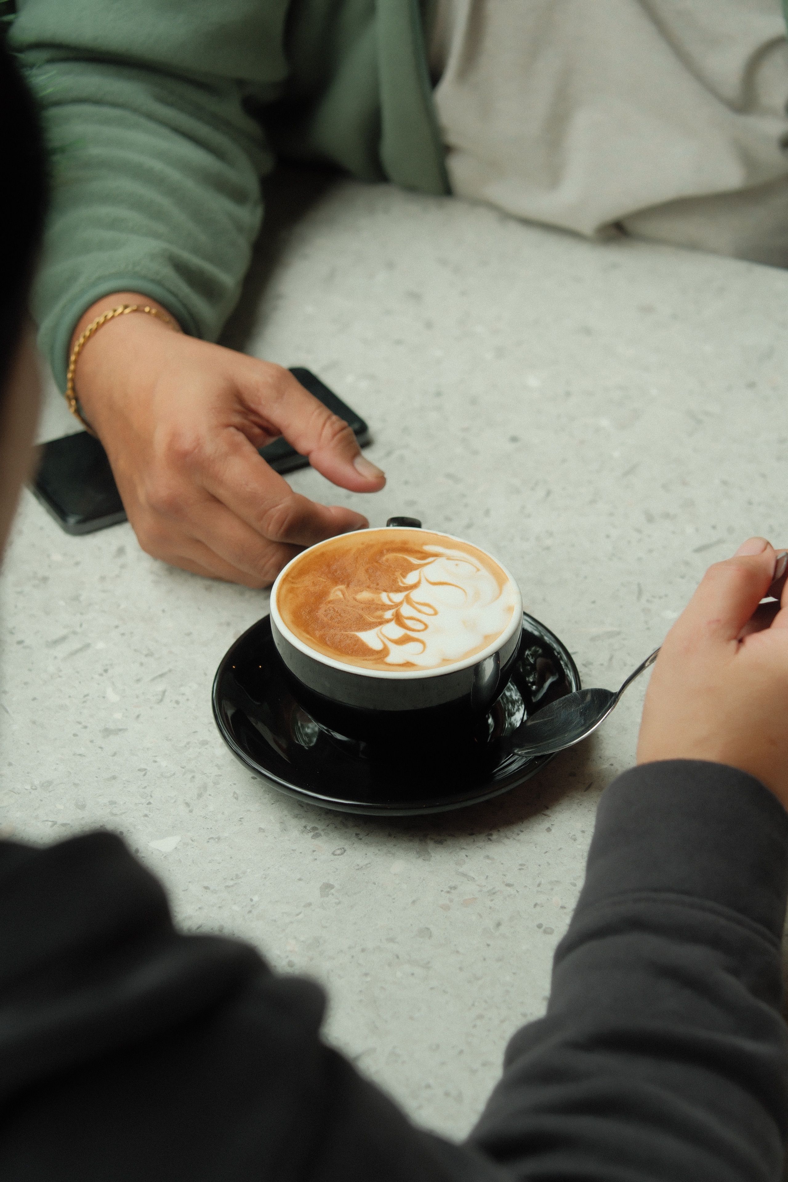 Cozy Coffee Meetup at a Café Table · Free Stock Photo