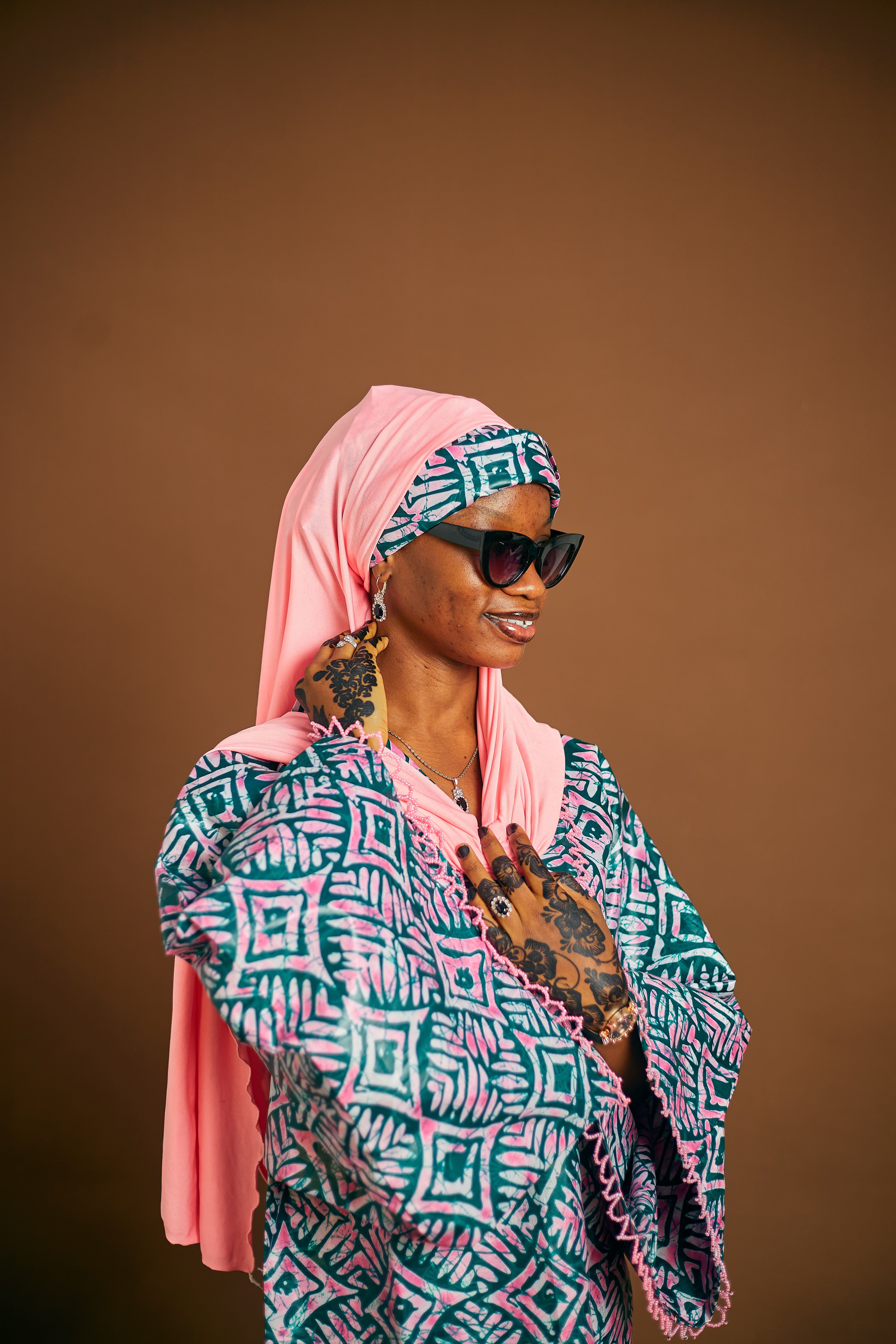 Stylish Woman in Traditional Attire with Pink Headscarf · Free Stock Photo