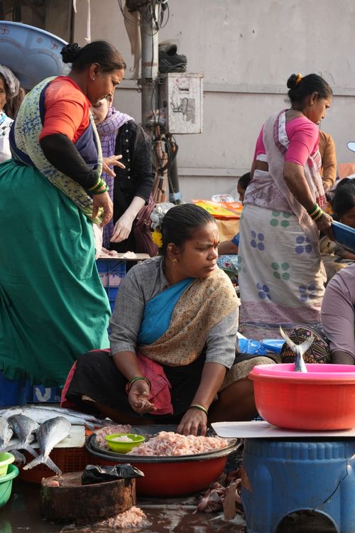 Free Local vendors selling fresh seafood at a bustling outdoor fish market. Stock Photo